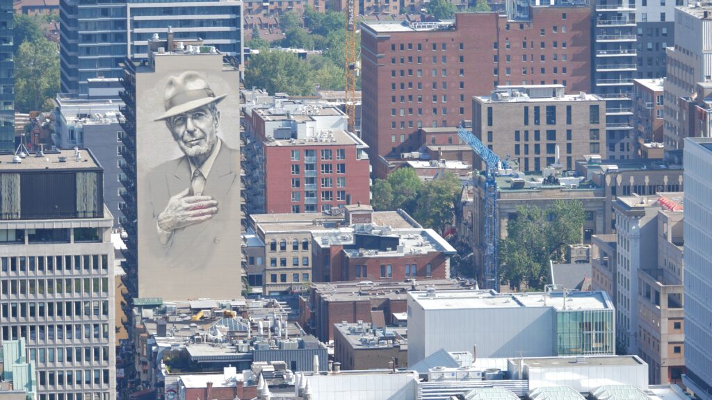 A view of buildings in the Plateau Montreal and Mile-End with a Leonard Cohen memorial mural on one of the buildings.