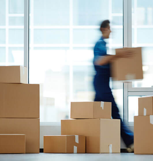 person.jpg Professional mover handling cardboard boxes during a residential relocation service.